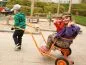 Preview: Children happily playing with the rickshaw on the playground Preview: Children happily playing with the rickshaw on the playground